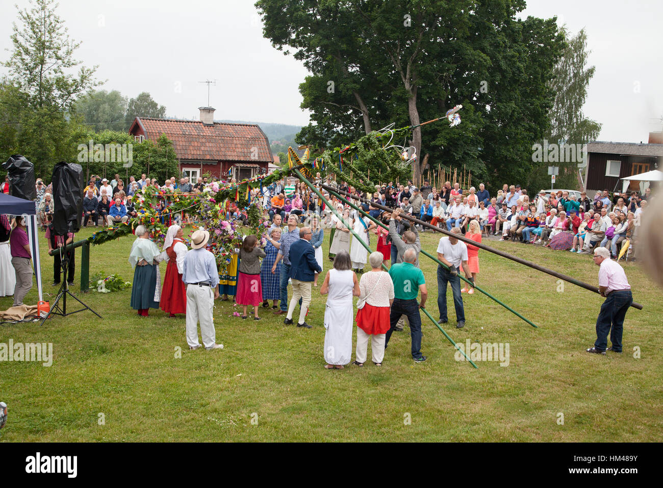 MIDSUMMER CELEBRATION when the Maypole  is raised by the celebration Stock Photo
