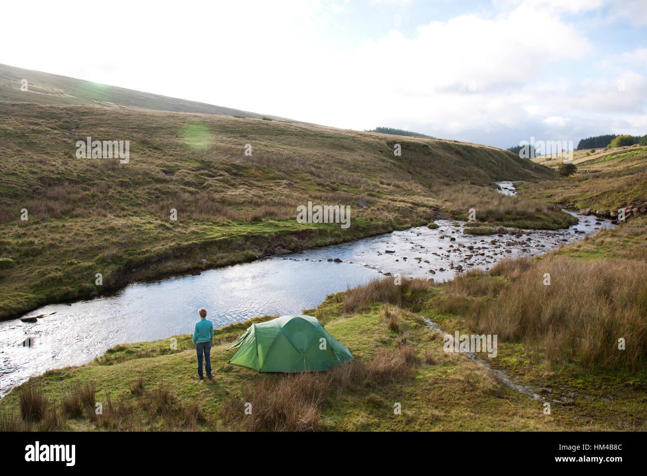 Wild camping by a river in a high valley in the Brecon Beacons, South Wales Stock Photo