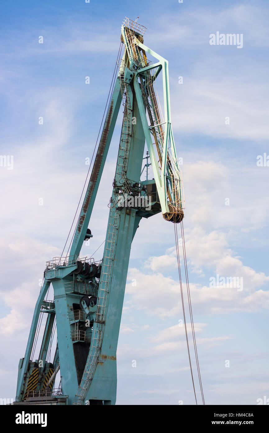 Crane in the seaport against the blue cloudy sky Stock Photo - Alamy