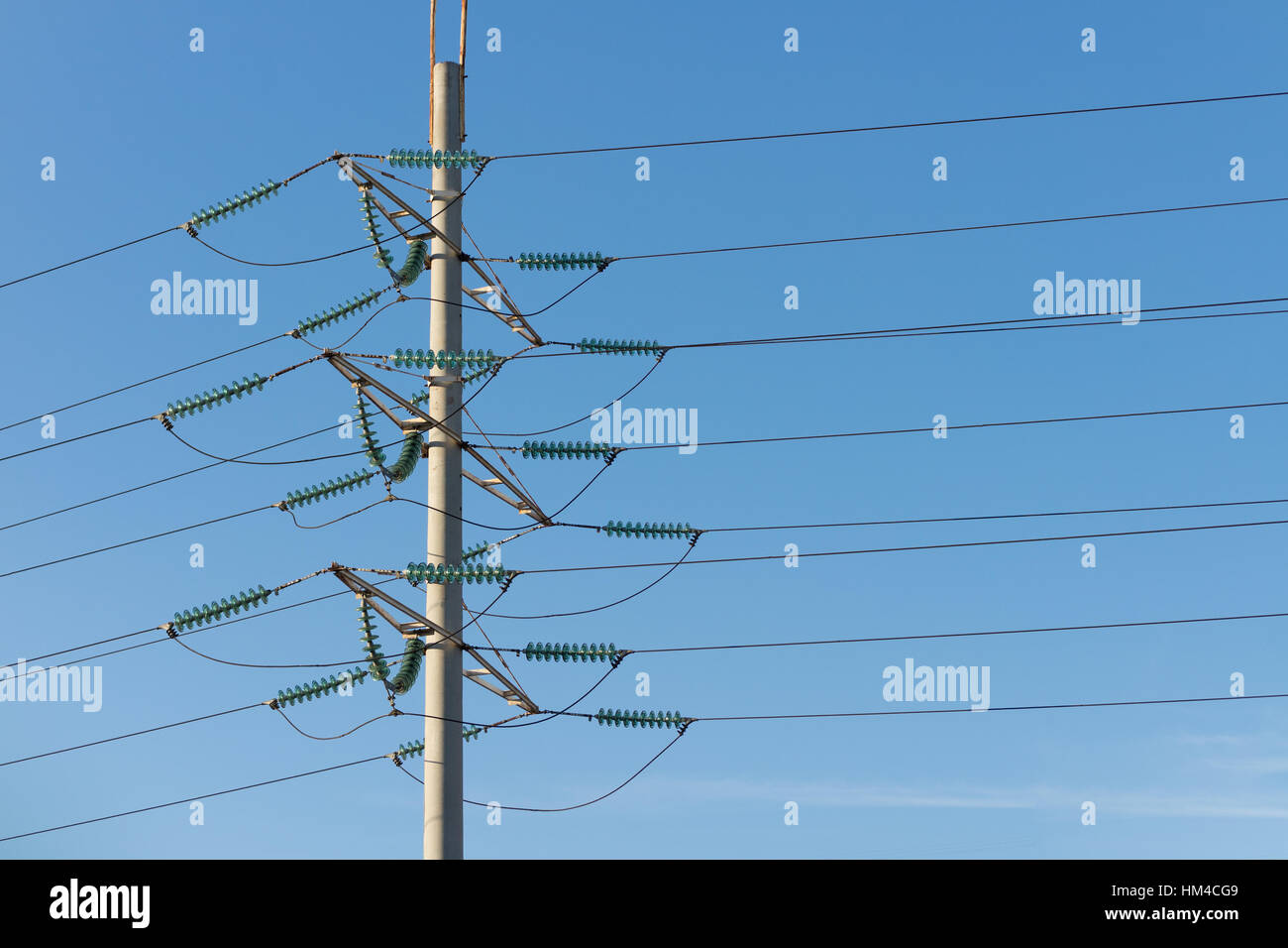 High voltage power pole against the blue sky in the sunlight Stock ...