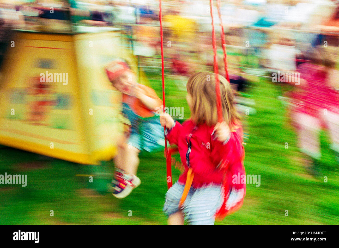 An abstract of children on a fairground ride with motion blur. Stock Photo