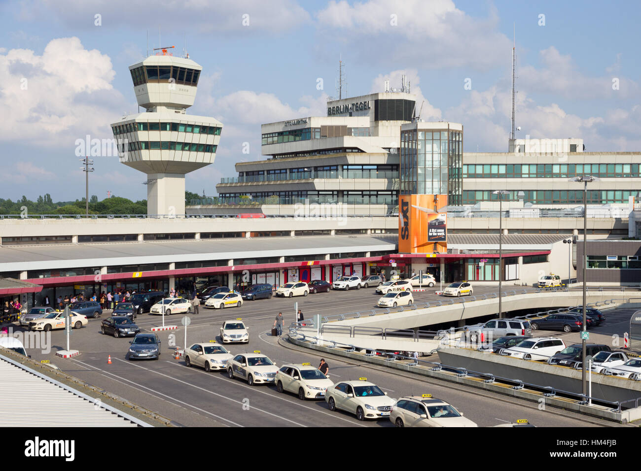 BERLIN - JUN 1, 2016: Taxi's in front of the airport terminal of Berlin-Tegel airport. This airport is the main international airport of Berlin. Stock Photo