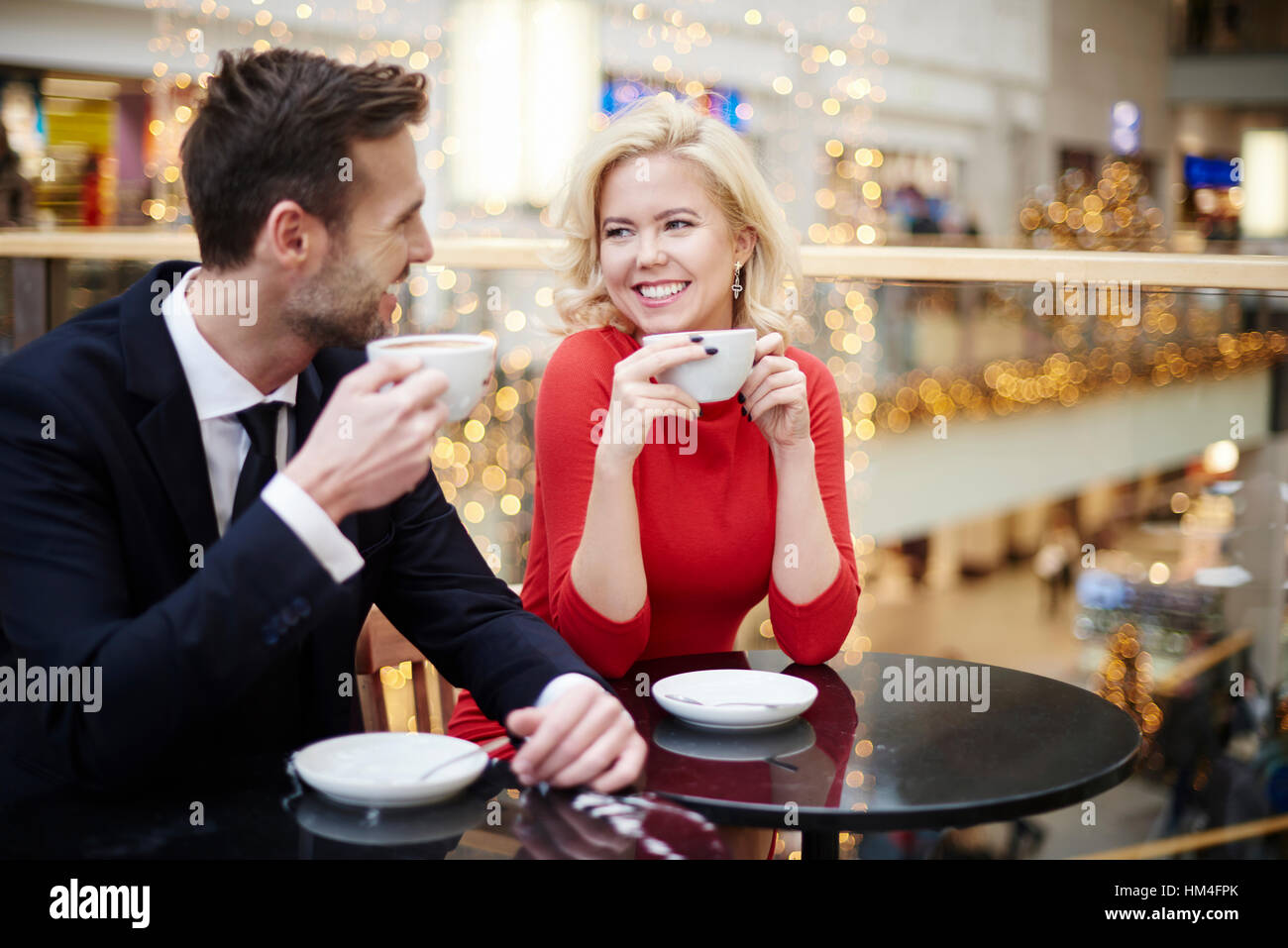 Couple drinking coffee at the shopping centre Stock Photo