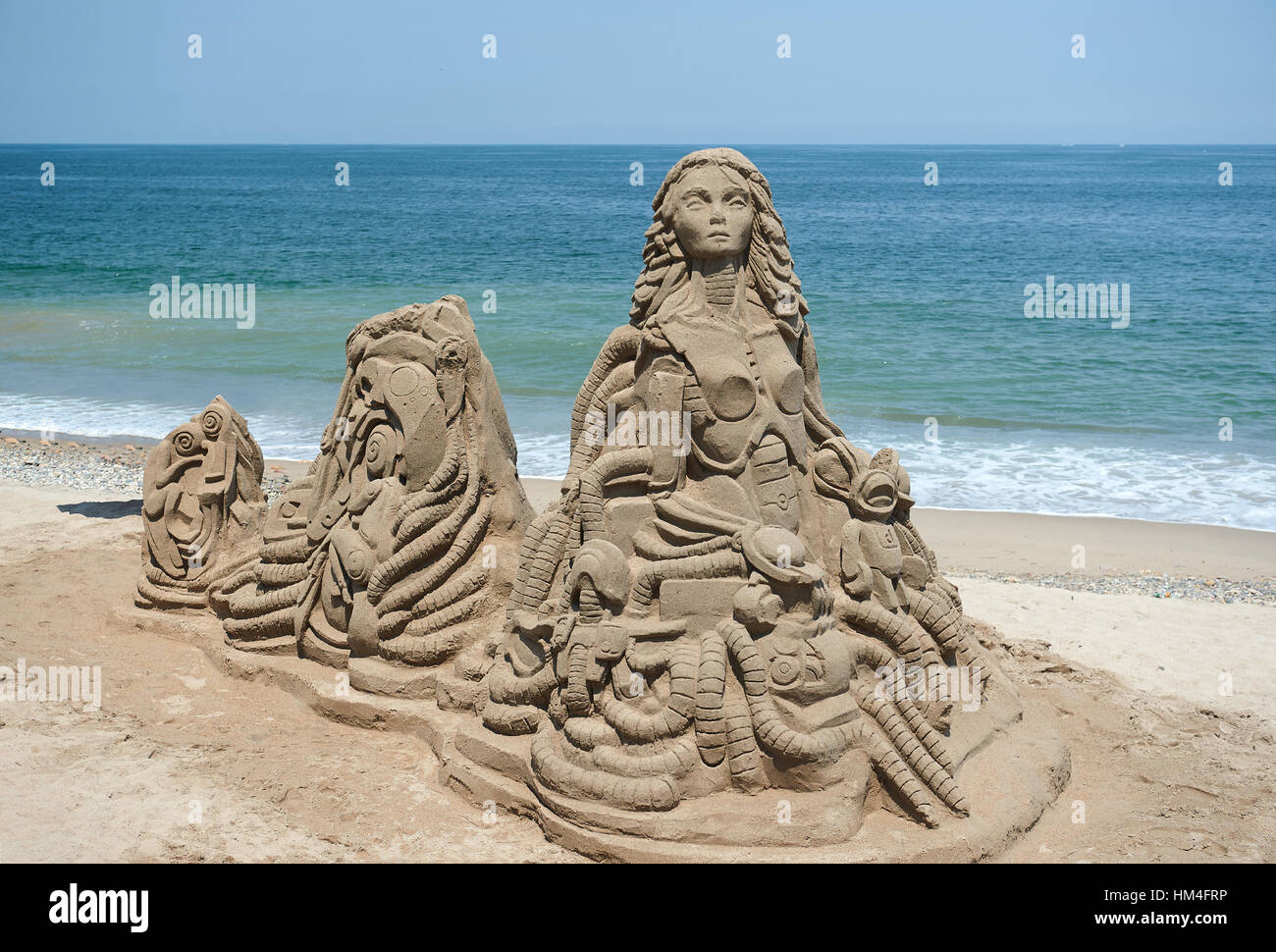 abstract sand statue on beach with ocean on background Stock Photo Alamy
