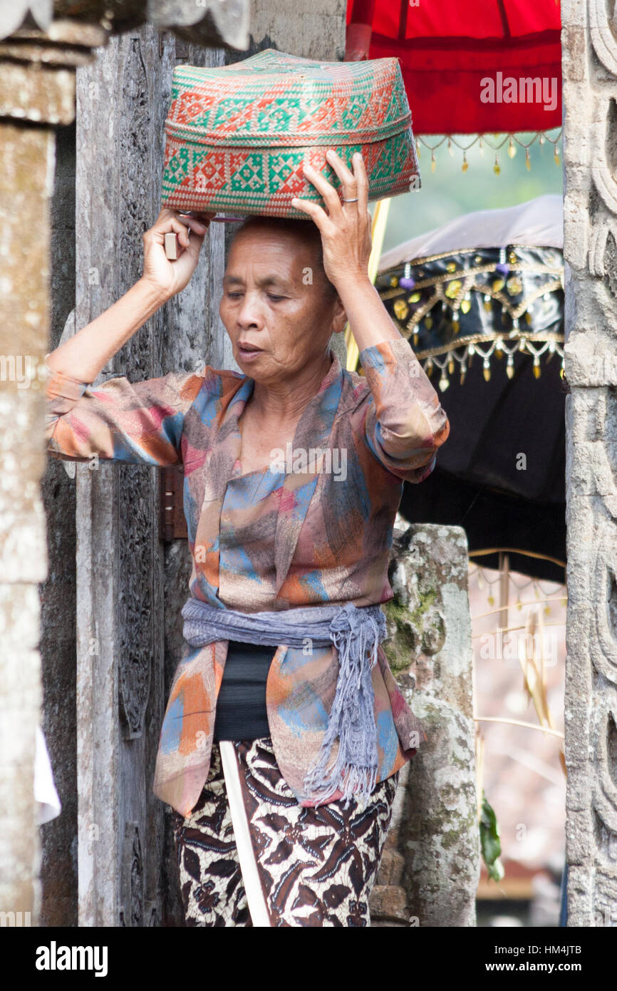 Woman carrying offerings to the temple during the Galungan festival Stock Photo