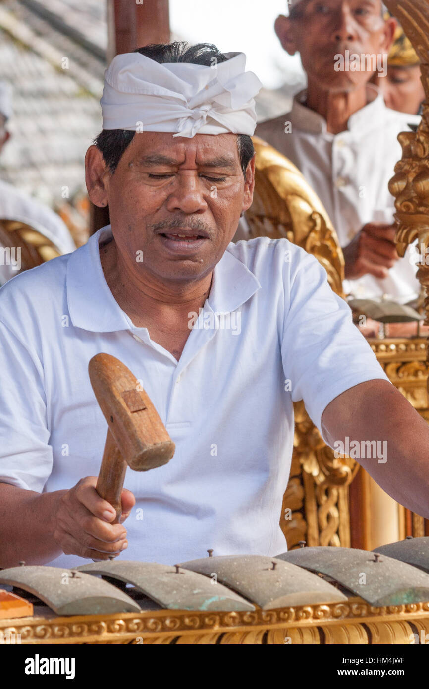 Man playing a metallophone in a gamelan orchestra in Bali Indonesia