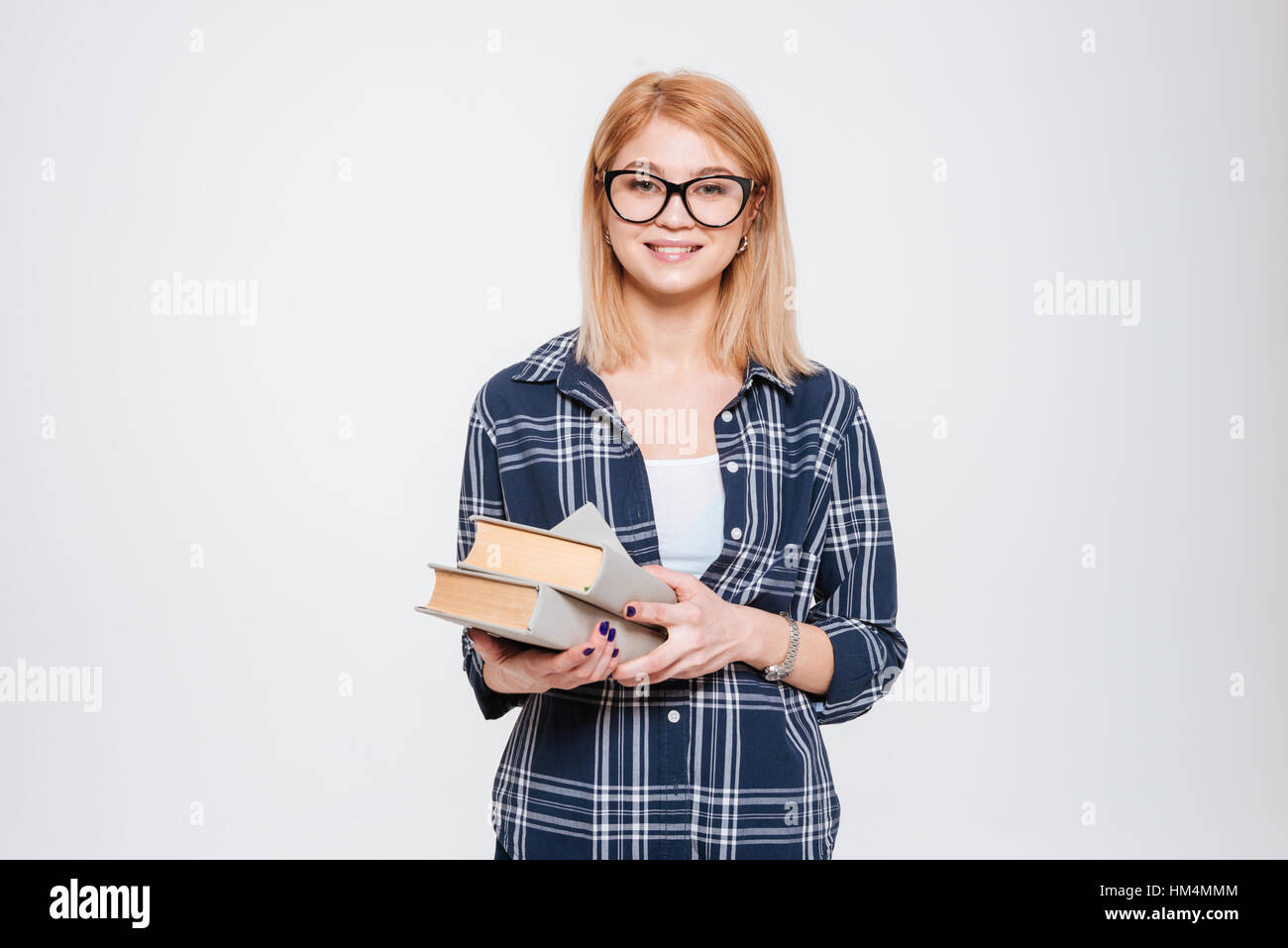 Image of pretty young lady holding books isolated on a white background ...