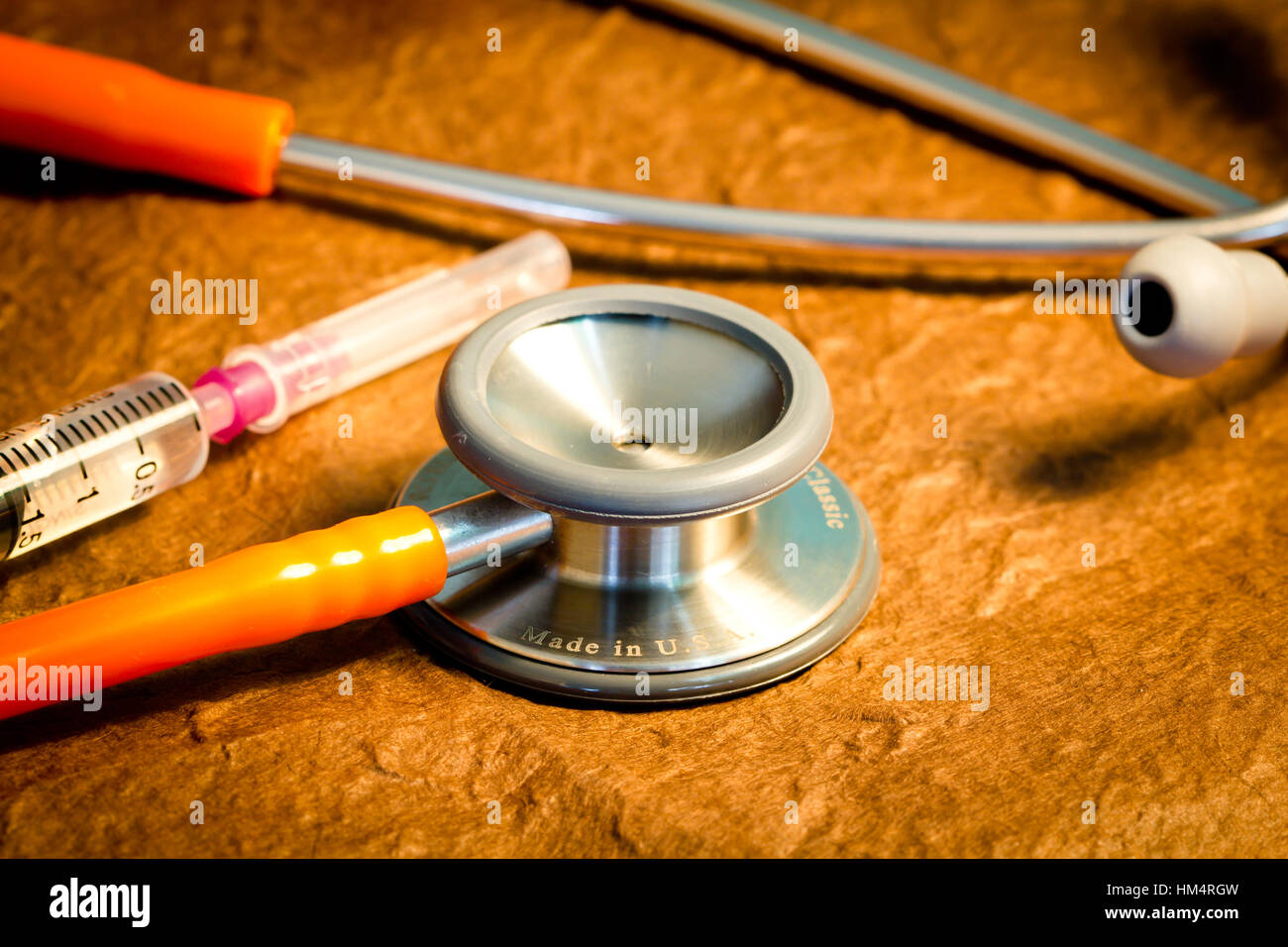 Medical stethoscope and syringe over brown background Stock Photo - Alamy