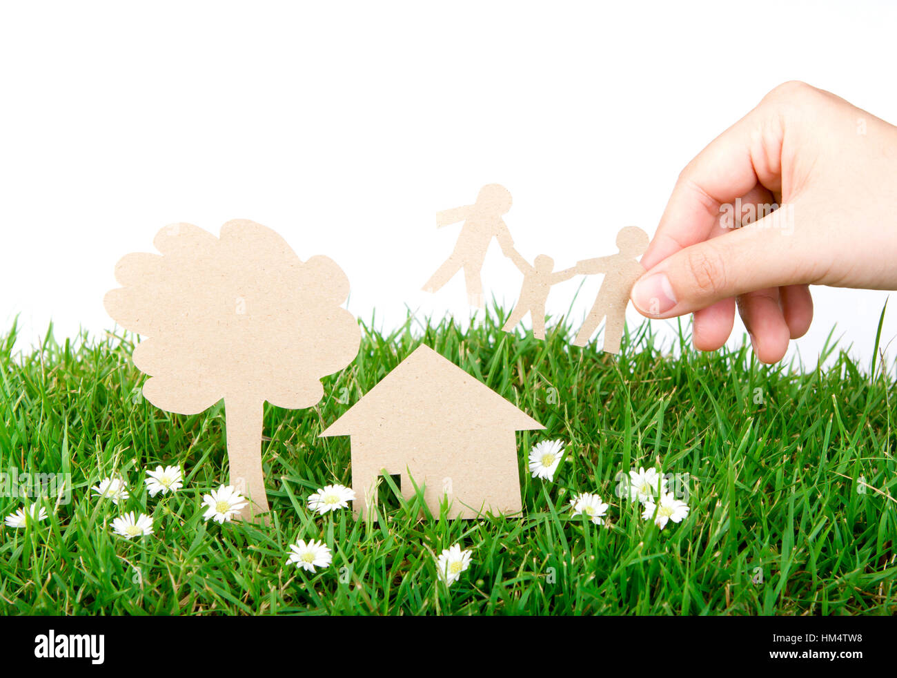 Hand hold paper cut of family over fresh spring green grass Stock Photo ...