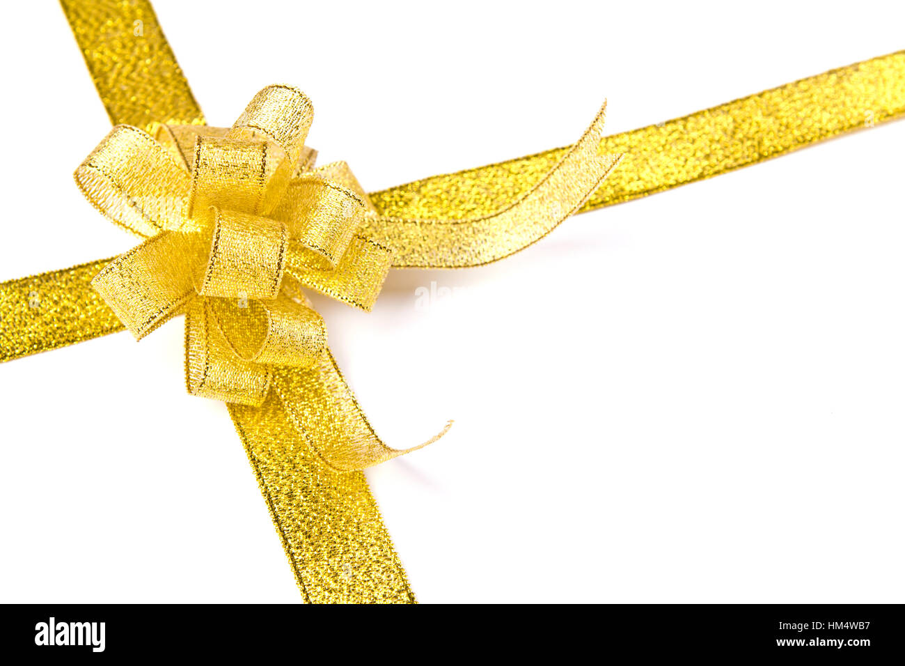 Gold ribbon with bow on white background Stock Photo - Alamy