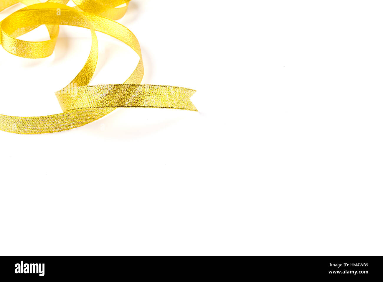 Gold ribbon with bow on white background Stock Photo - Alamy
