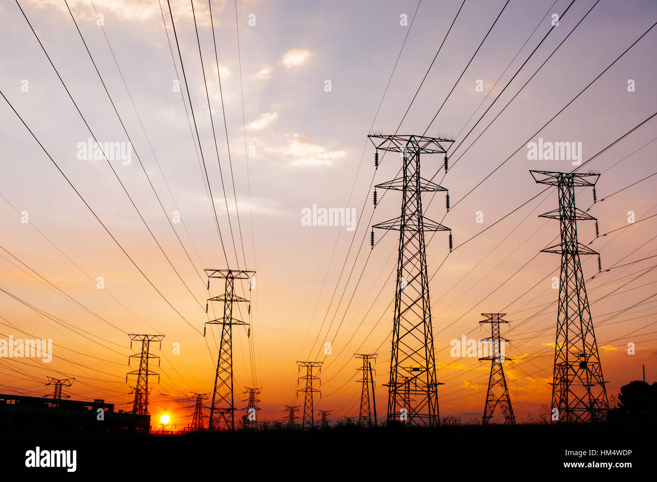 Electricity pylons and power lines, at sunset Stock Photo - Alamy