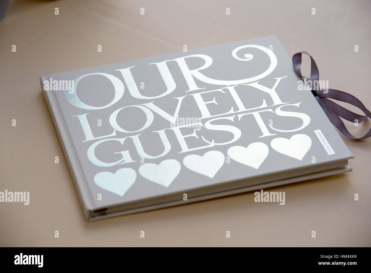 Wedding guestbook sat on a table with large word love at a wedding in Sussex, UK. Guests sign it with their heartfelt messages Stock Photo