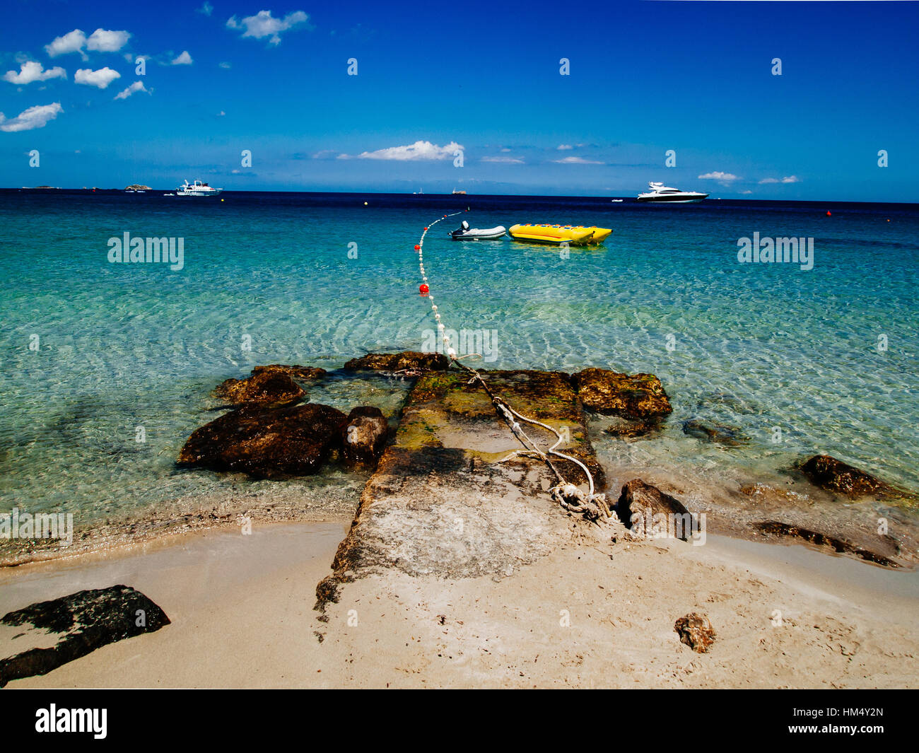 Anchored motoryacht in turquoise ibiza beach of playa d'en bossa, Spain Stock Photo