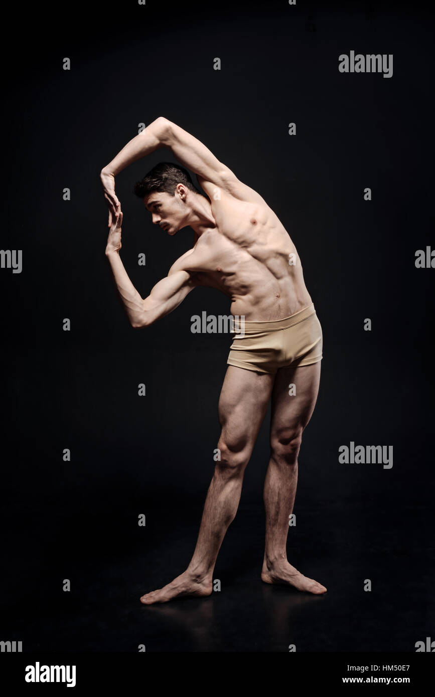 Graceful ballet dancer stretching in the studio Stock Photo