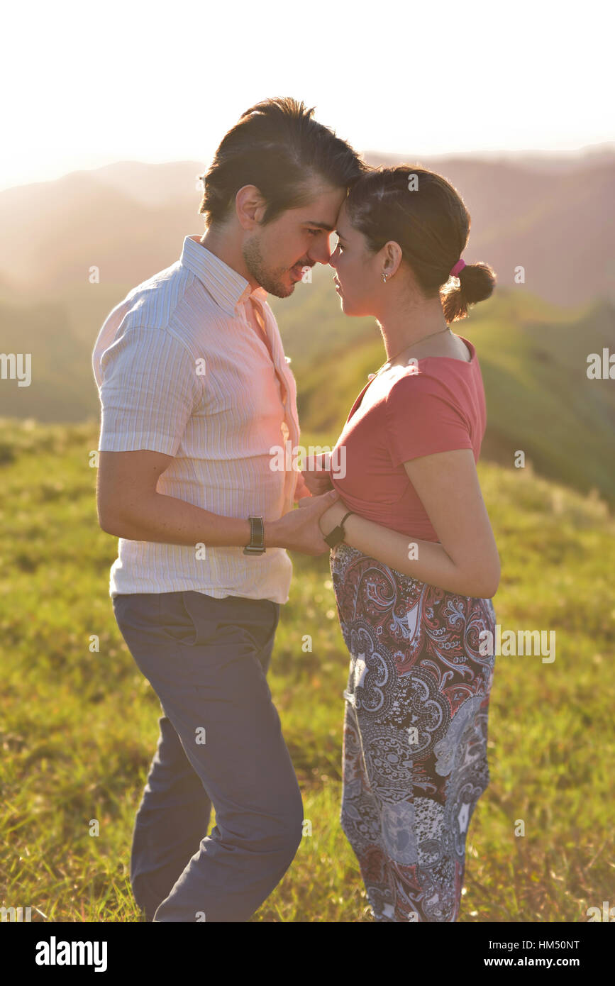 Couple in love stand face to face on light summer sun Stock Photo