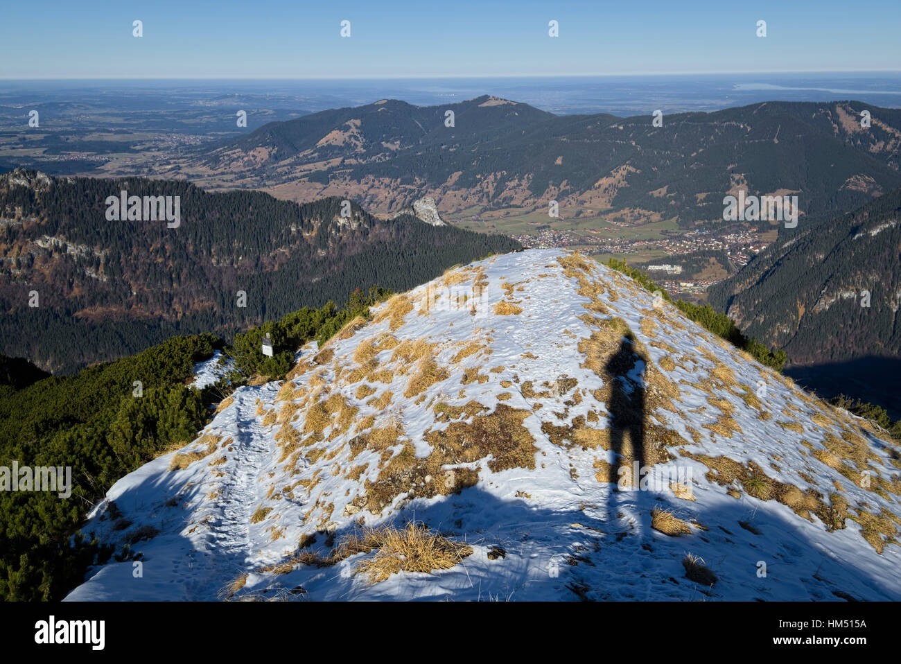 large shadow of hiker taking picture at summit of mountain Notkarspitze, Bavaria, Germany Stock Photo