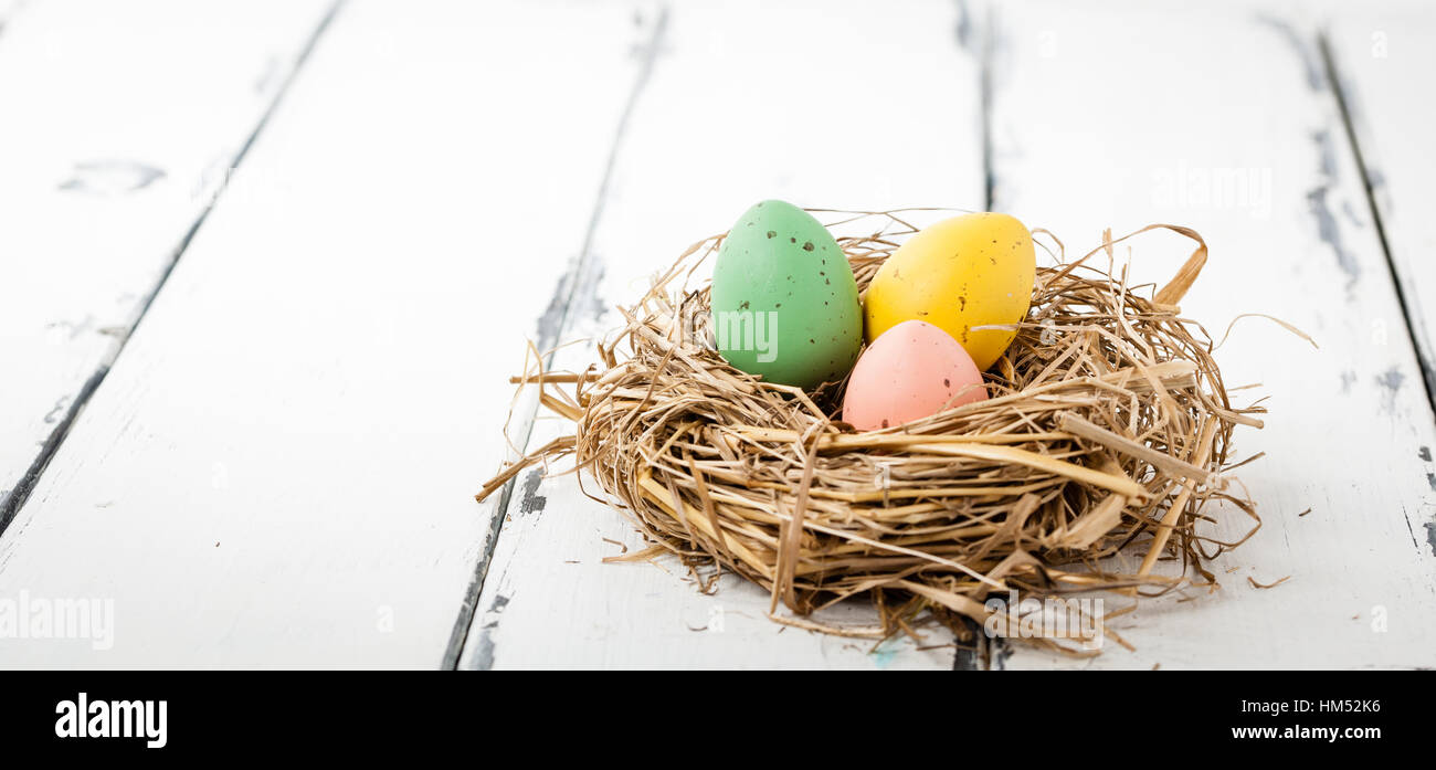 three ester eggs in a bird nest Stock Photo