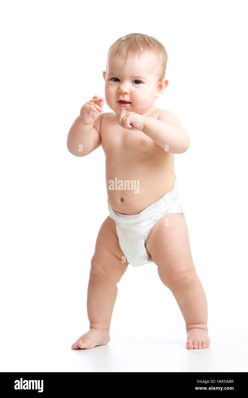 Cute smiling baby learning to walk. Kid weared diaper Isolated on white background. Stock Photo