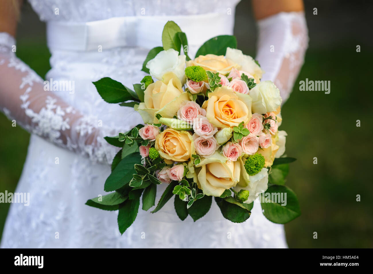 Bride holding beautiful wedding bouquet on a walk Stock Photo