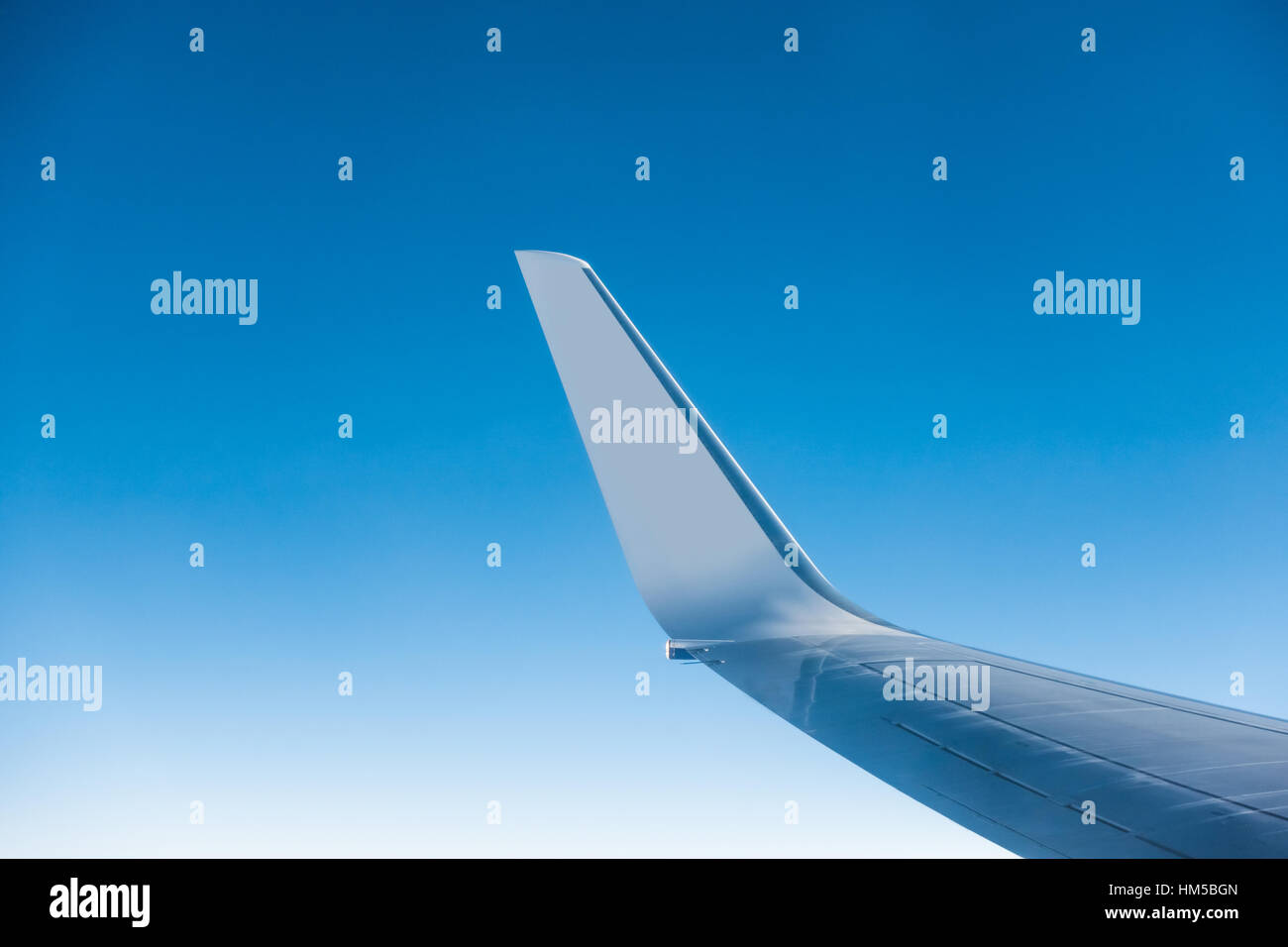 Wing of an aircraft and blue sky Stock Photo - Alamy
