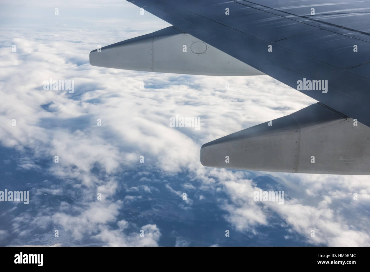 Wing of an aircraft and cloudy sky Stock Photo - Alamy