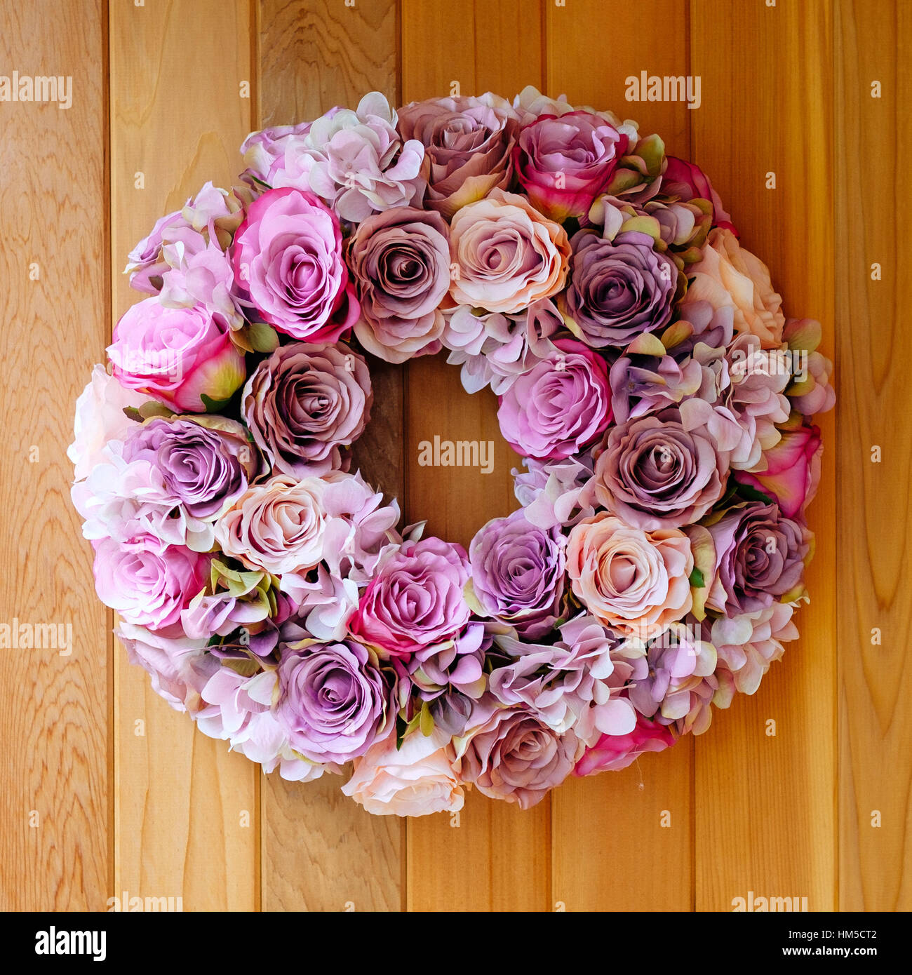 A handmade silk flower circular wreath made from pink roses Stock Photo