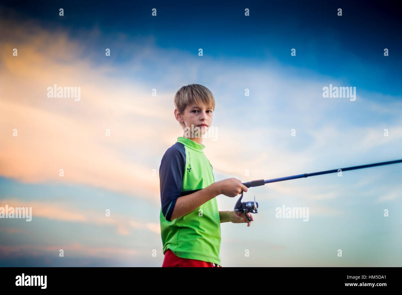 blond teenage boy with fishing pole Fishing blond boy hi-res stock photography and images