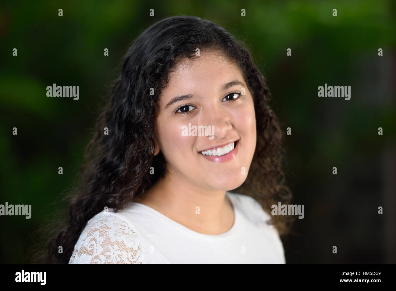 teen girl with curly long hair smiling Stock Photo