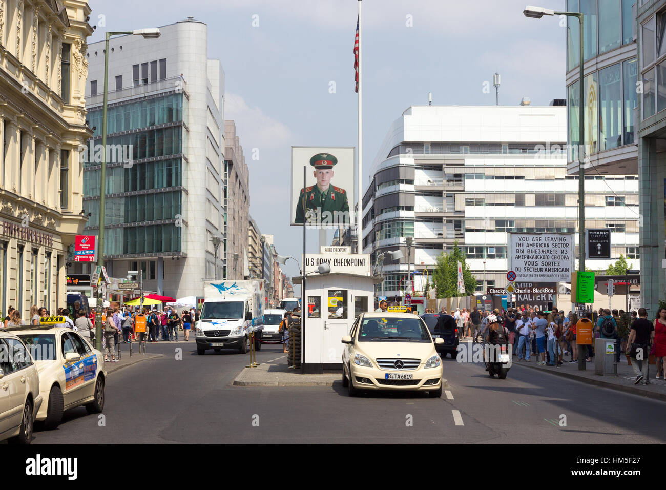 BERLIN, GERMANY - MAY 23: Tourists around the former Allied checkpoint 'Charlie' on May 23, 2014. Nowadays this site is a tourist attraction. Stock Photo