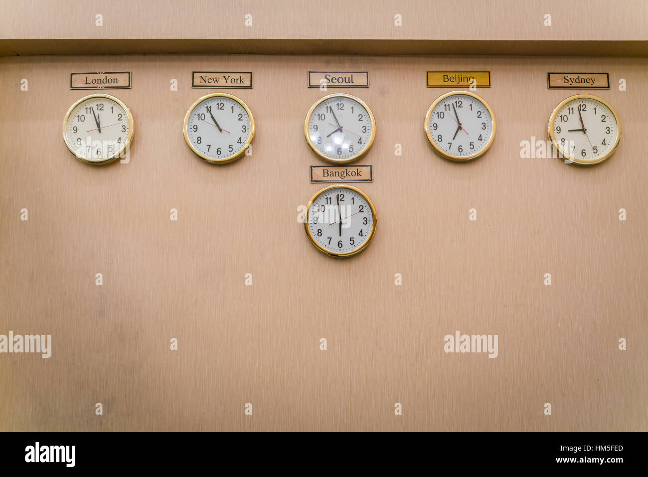 Clocks shows different time zones on old wall Stock Photo Alamy