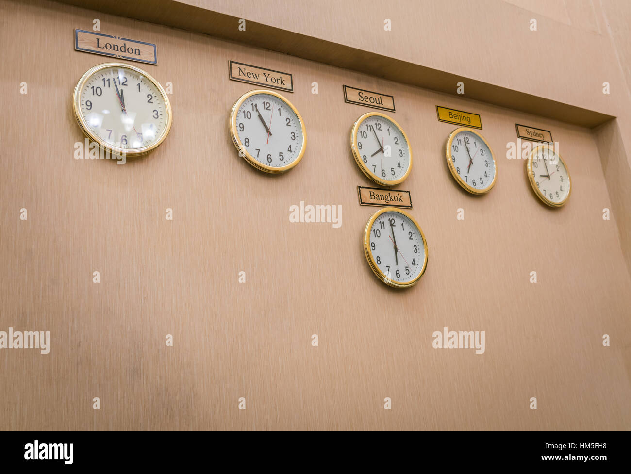 Clocks shows different time zones on old wall Stock Photo Alamy