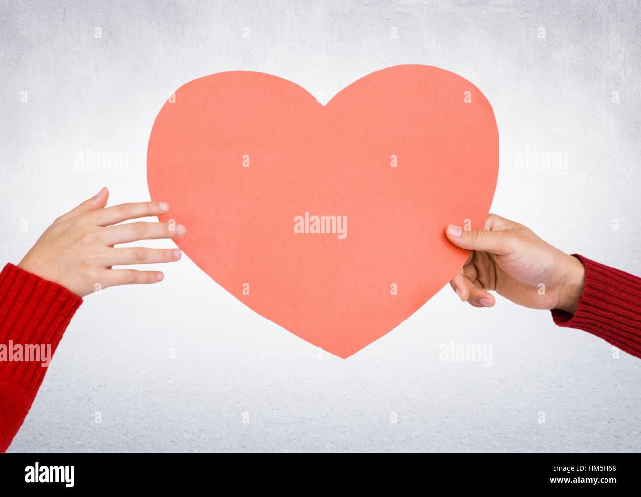Hands holding a red heart Stock Photo - Alamy