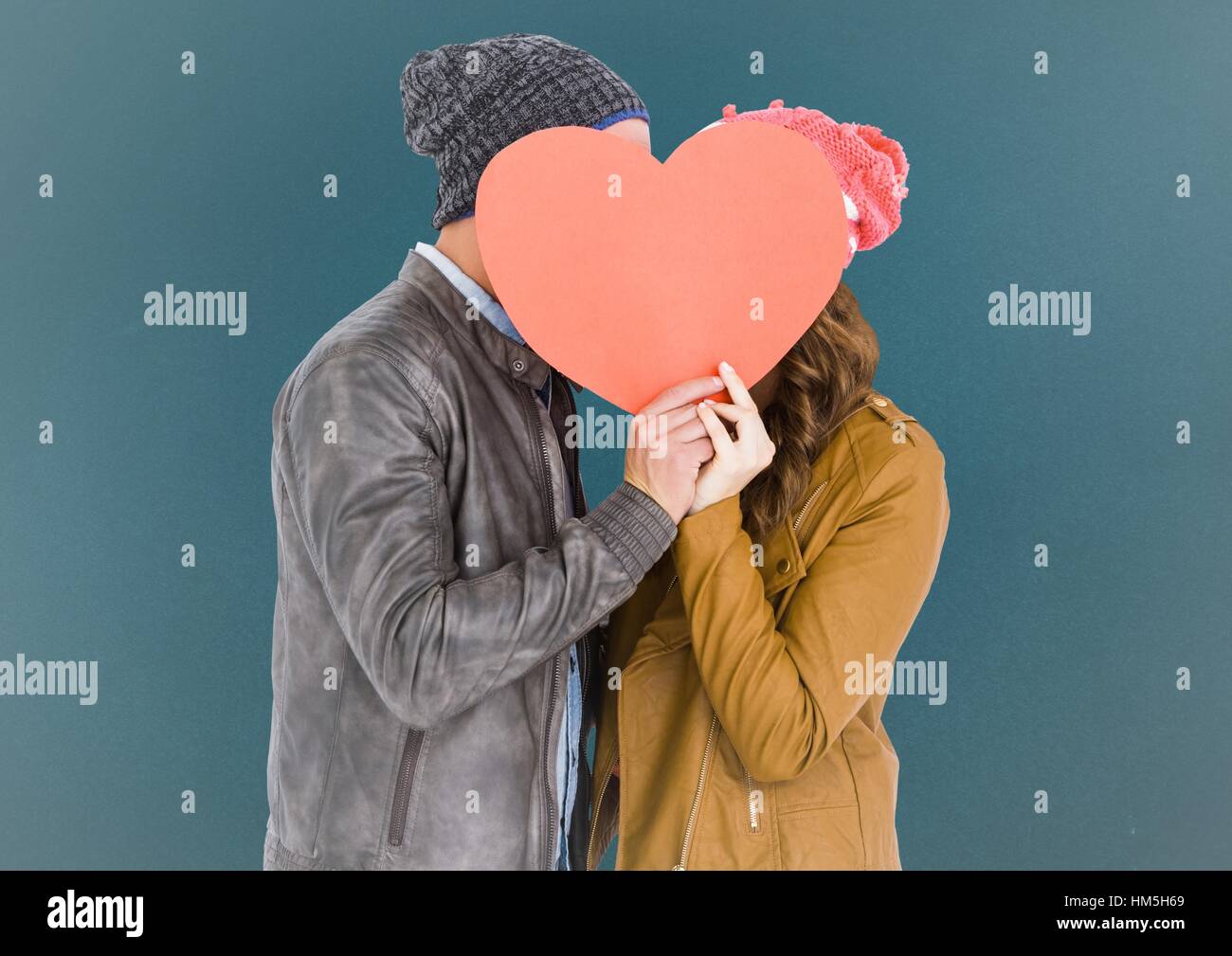 Romantic couple holding heart shape and kissing each other Stock Photo ...