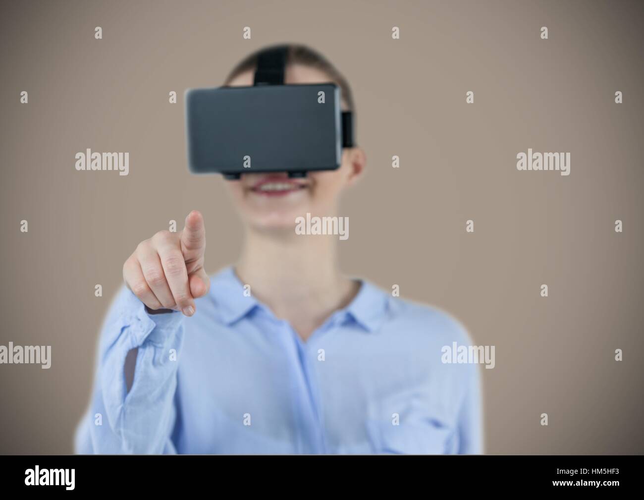 Smiling businesswoman using virtual reality headset Stock Photo - Alamy