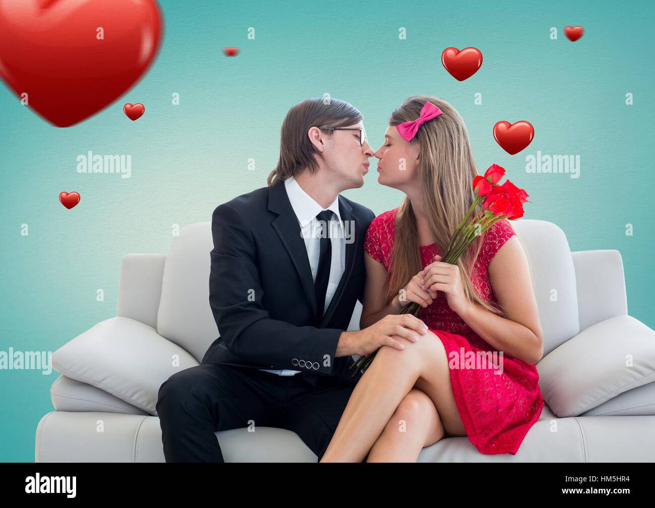 Romantic couple in love while sitting on a sofa Stock Photo - Alamy