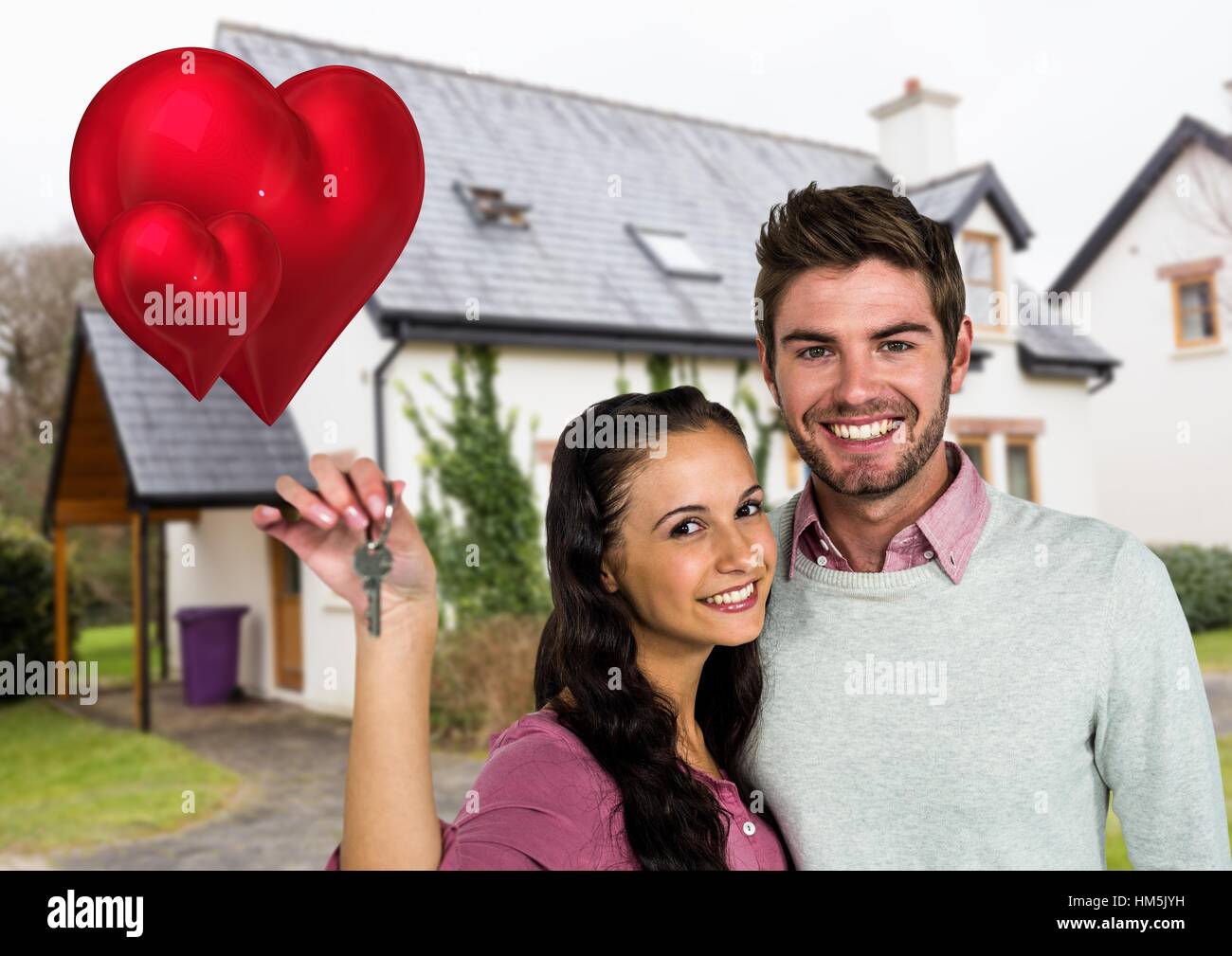 Portrait of couple showing new home key Stock Photo - Alamy
