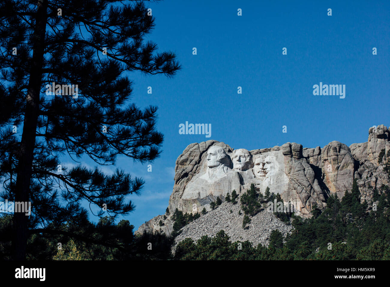 View of Mt Rushmore national monument against blue sky Stock Photo
