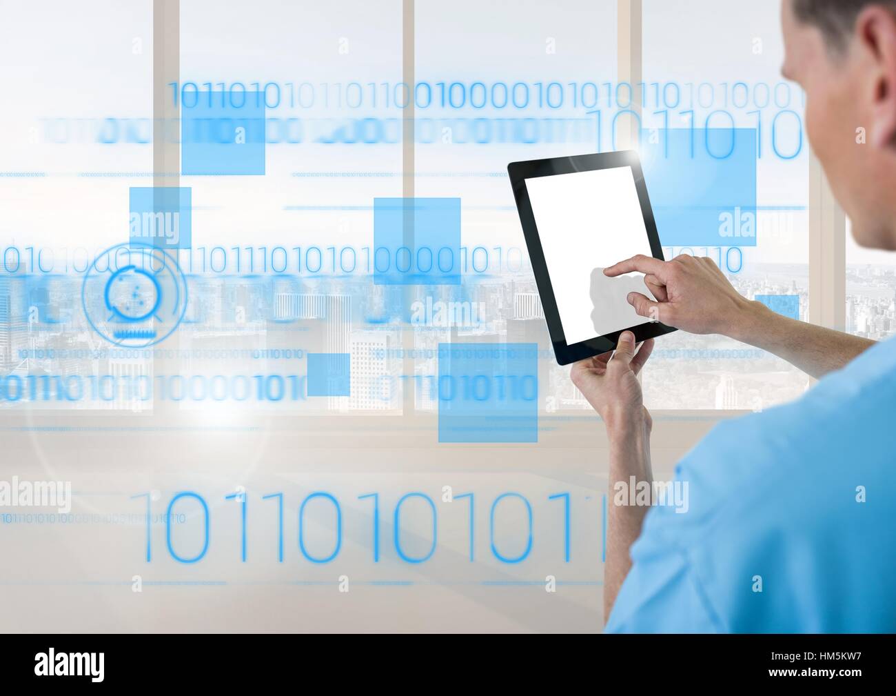 Doctor using digital tablet with blue interface in front of window ...