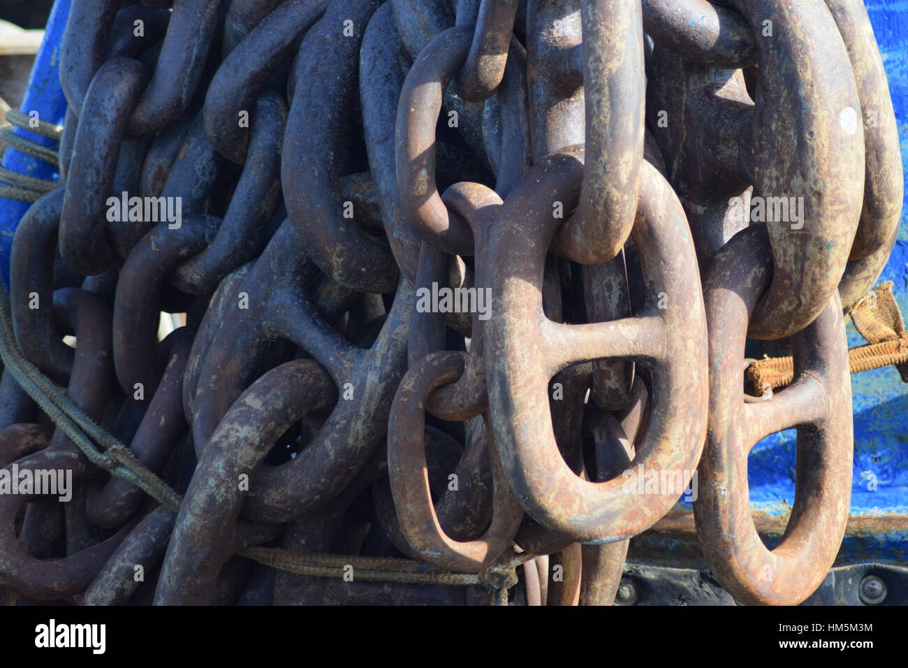 Rusty anchor chains on fishing boat Stock Photo