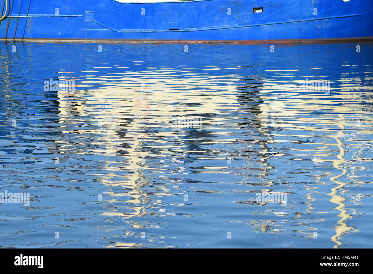 Reflection of fishing boat in the water Stock Photo