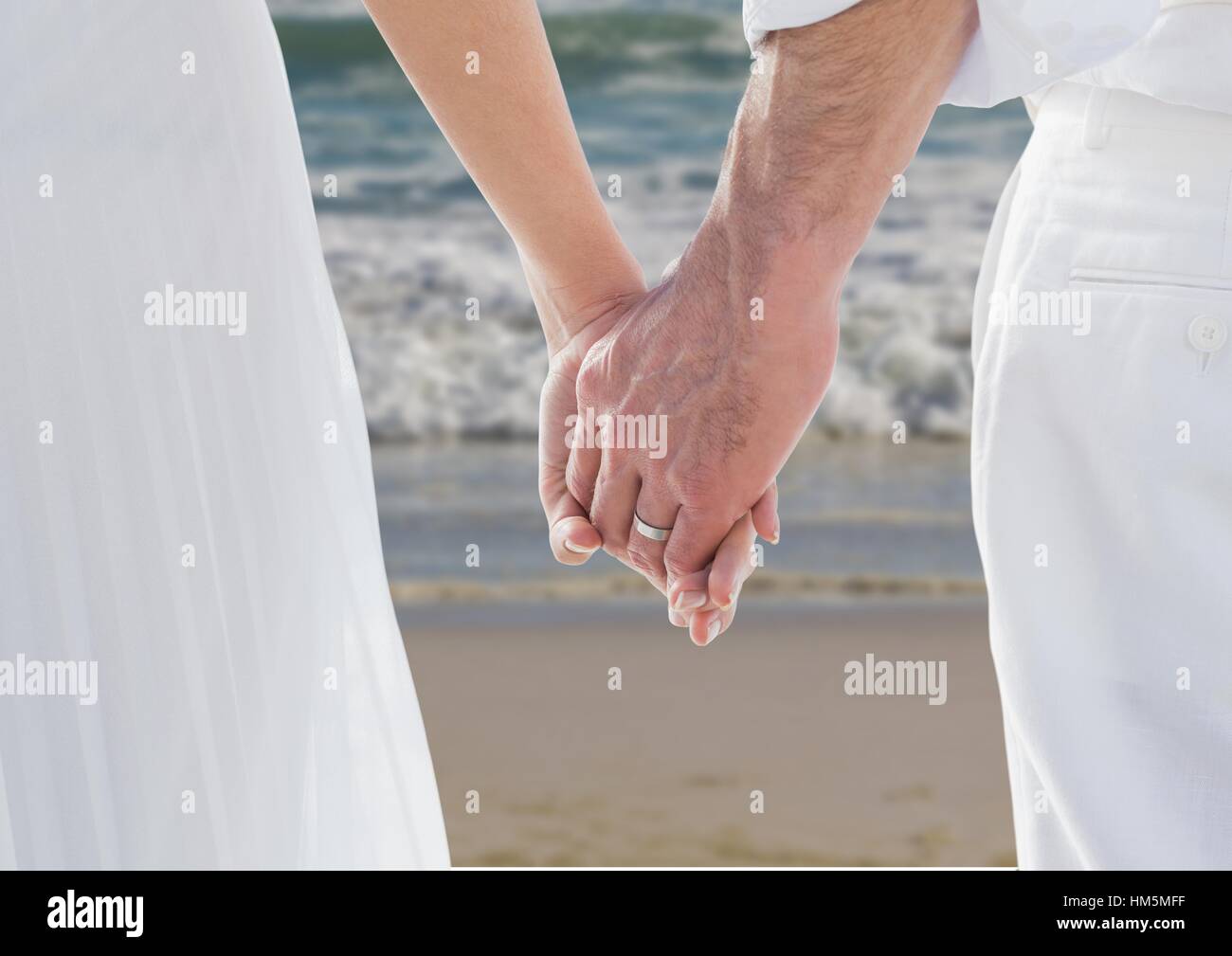 Newly wed couple holding hands Stock Photo