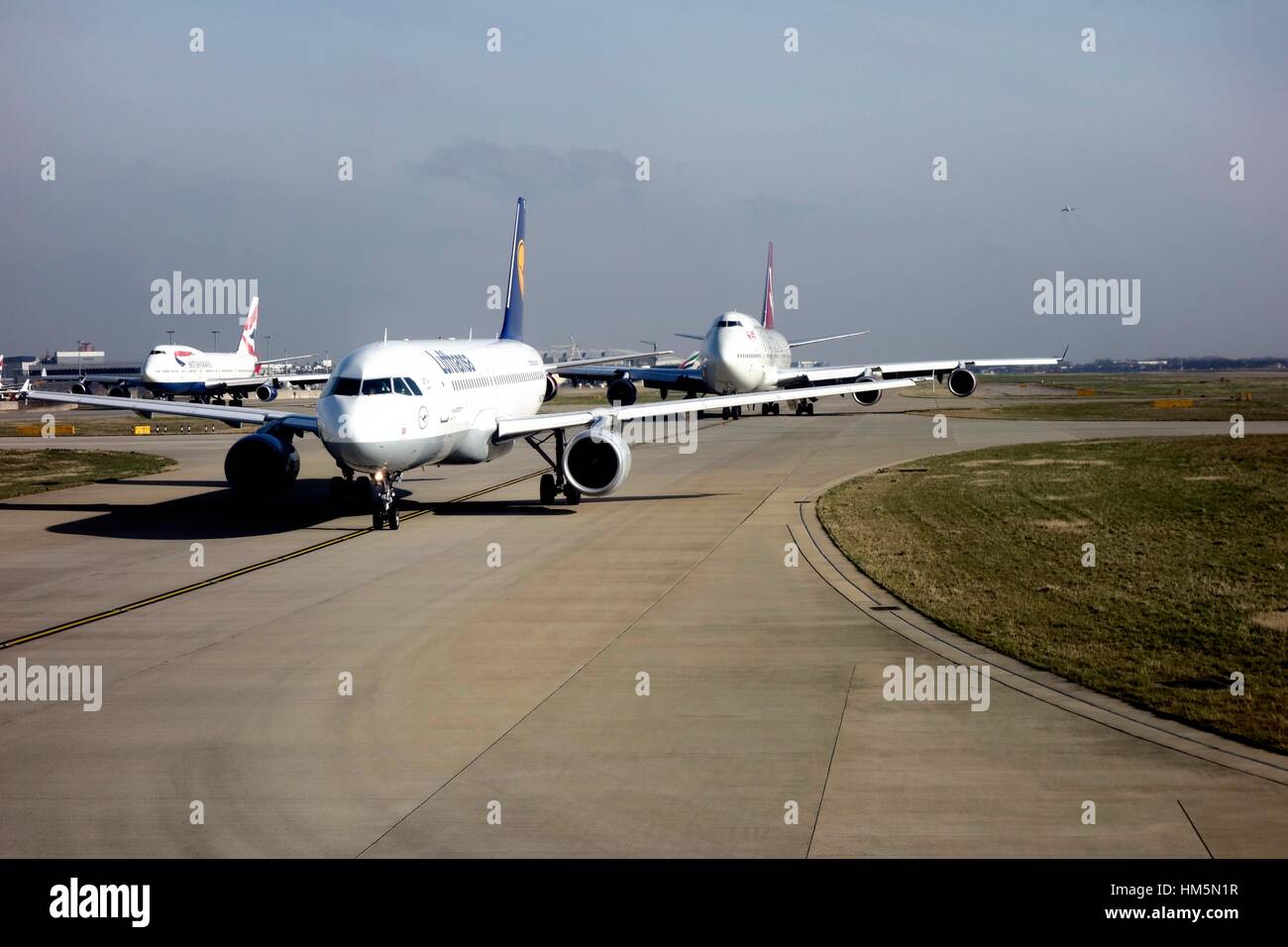 Airplanes queue for a takeoff slot at London Heathrow Stock Photo