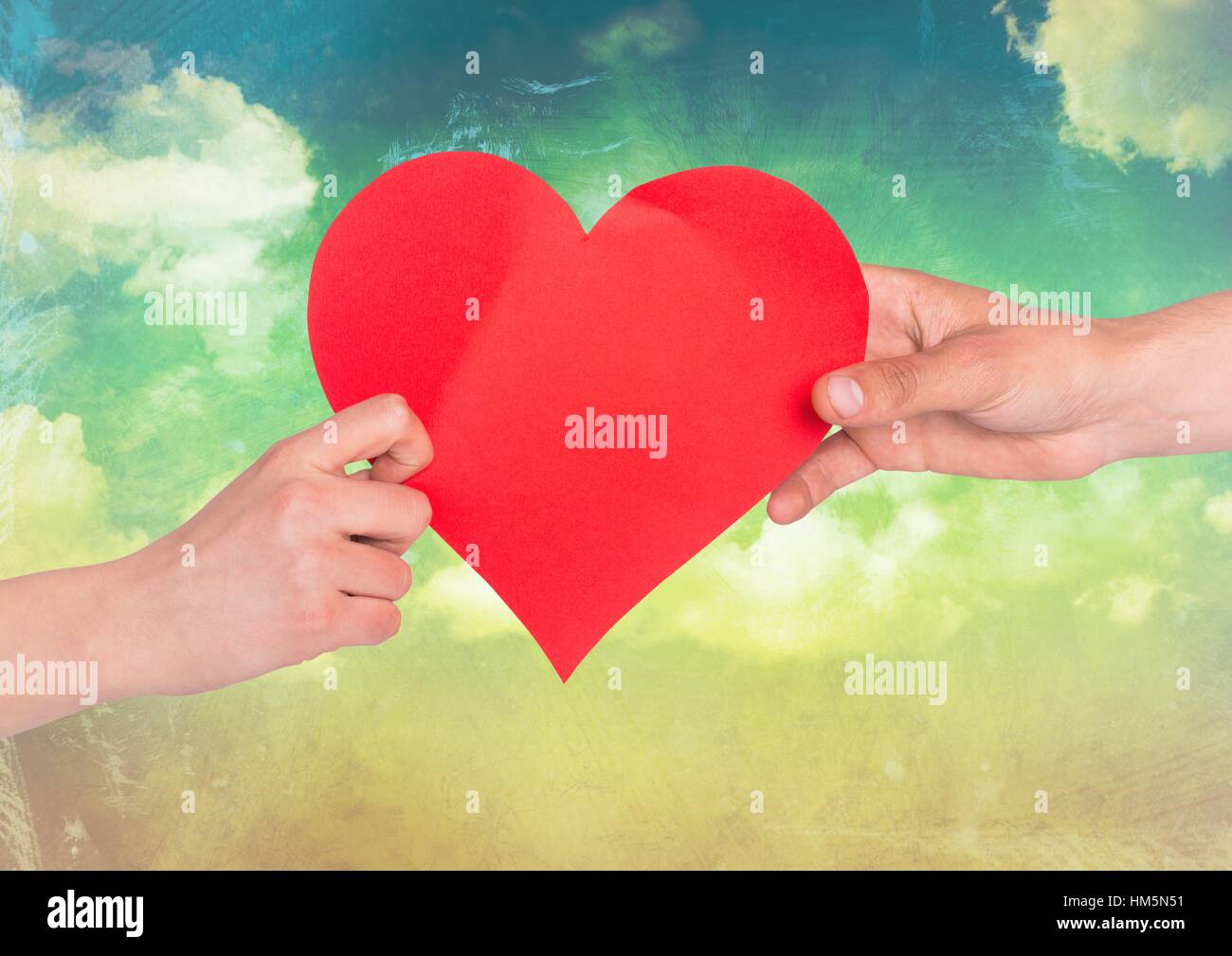 Hands of couple holding red heart Stock Photo - Alamy