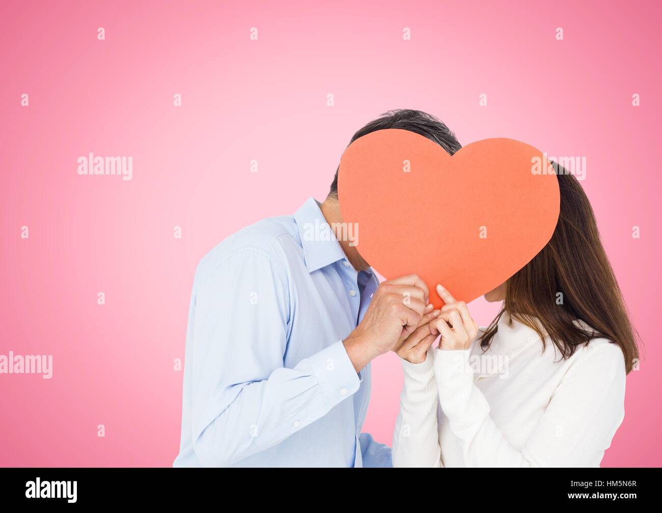 Romantic couple holding heart shape and kissing each other Stock Photo ...
