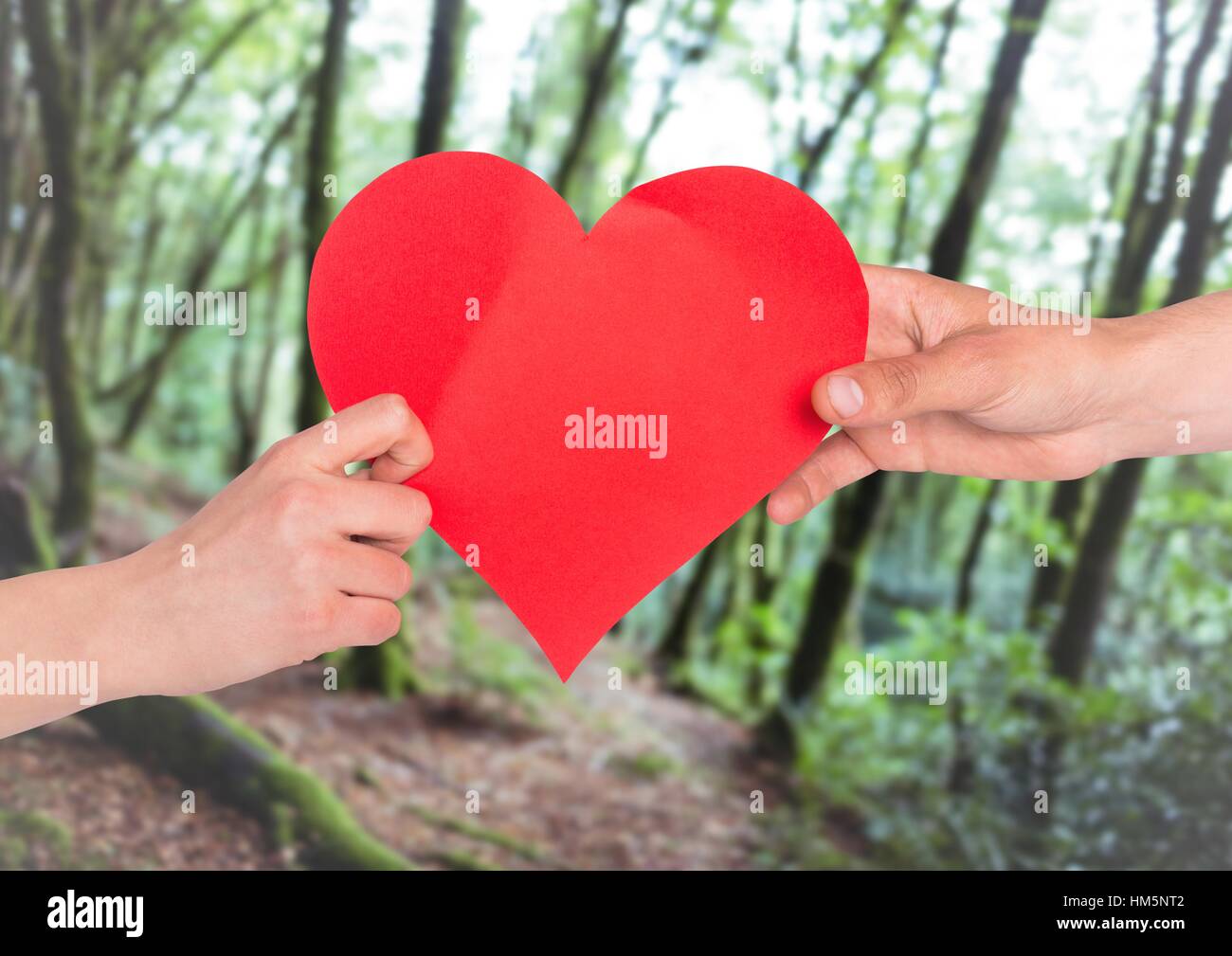 Hands of couple holding red heart Stock Photo - Alamy