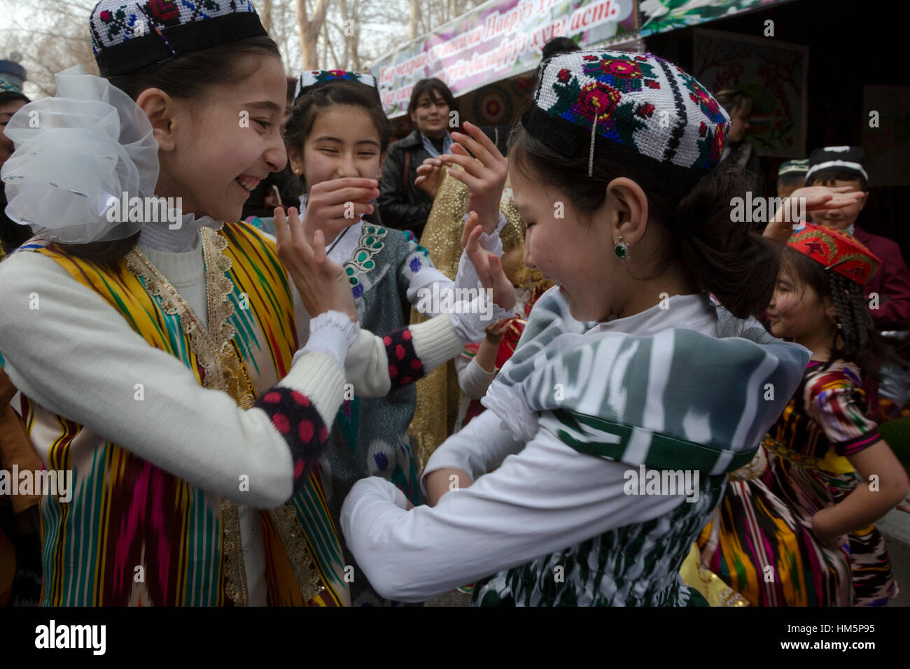 Girls dancing traditional oriental dance during the celebration of Navruz in Khujand city in Republic of Tajikistan Stock Photo