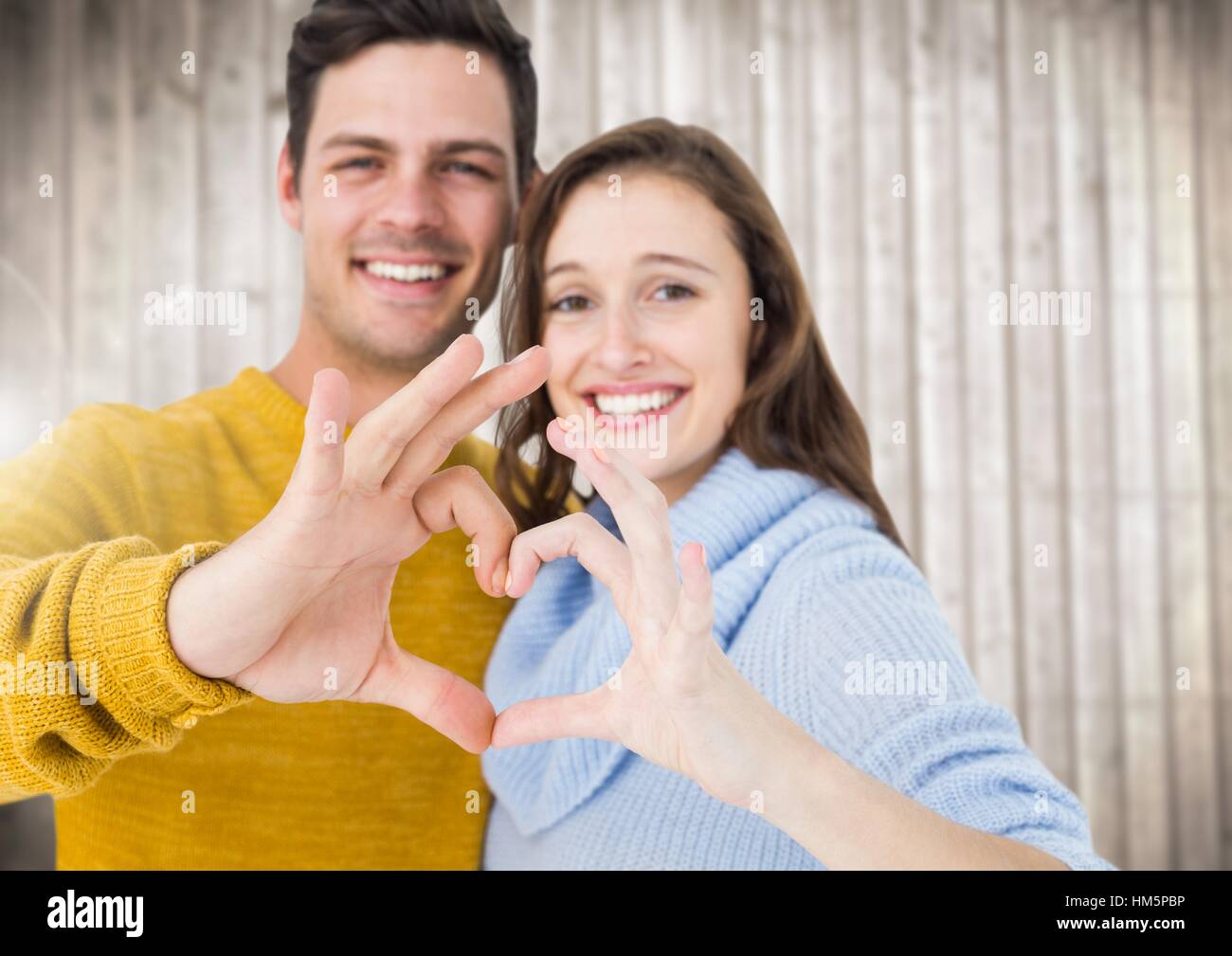 Young couple making a heart symbol with hands Stock Photo - Alamy