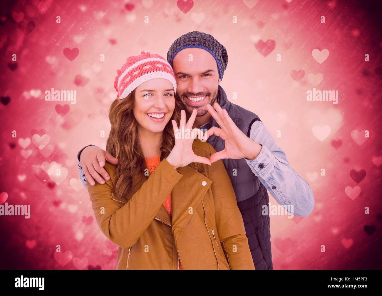 Happy couple making a heart symbol with hands Stock Photo - Alamy