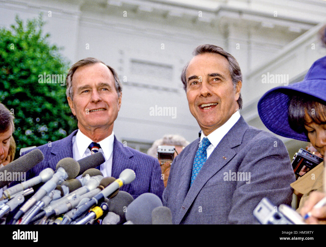 United States President-elect George H.W. Bush and U.S. Senate Republican Leader Bob Dole (Republican of Kansas) meet reporters at the White House in Washington, D.C. following their luncheon meeting on November 28, 1988. Stock Photo